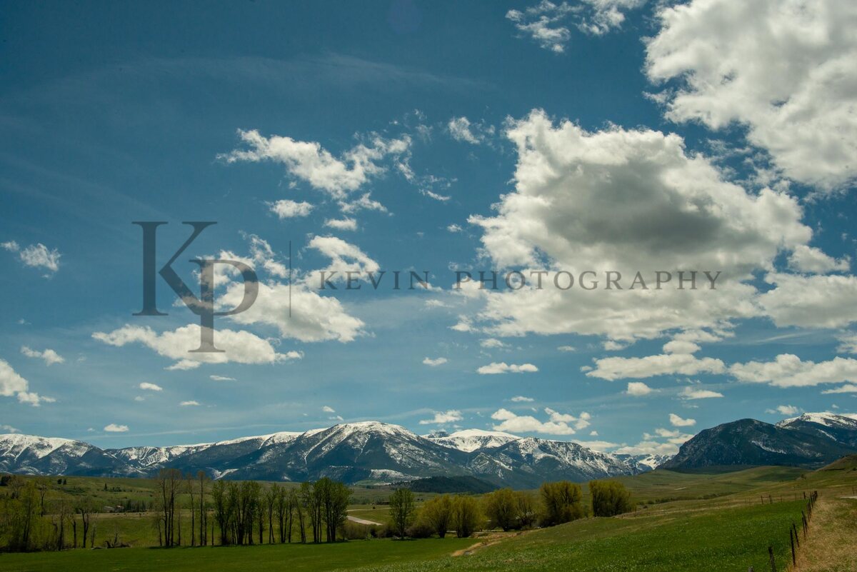 A vast Montana sky filled with clouds above a distant mountain line.