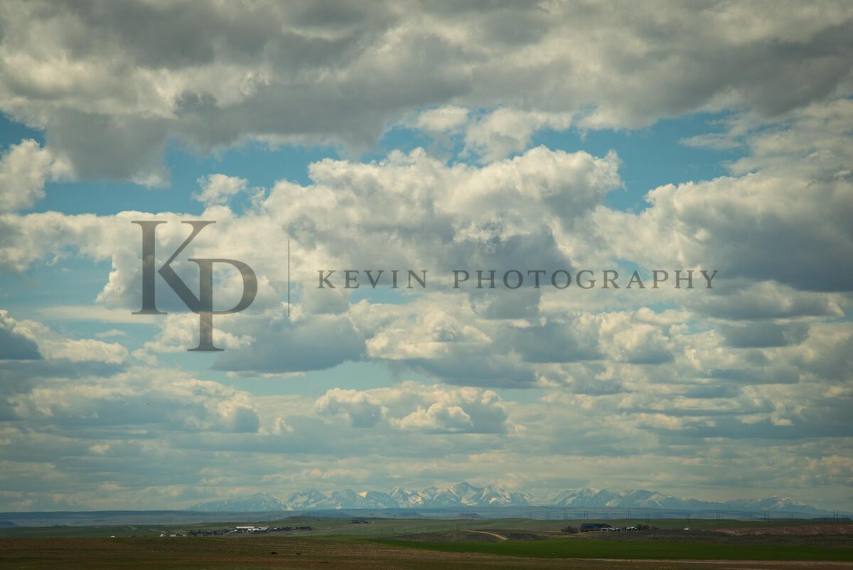 A sweeping Montana cloudscape stretched over open range and distant peaks.